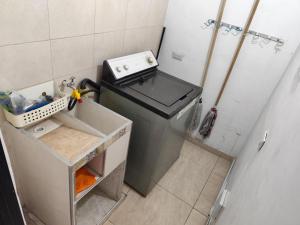 a small kitchen with a stove and a sink at Wil Hostal Apt 203 in Cali