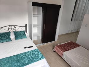a bedroom with a bed and a black door at Edificio Wil Hostal Apt 203 in Cali