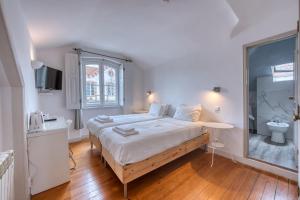 a bedroom with a large bed and a bathroom at Monte da Lua in Sintra