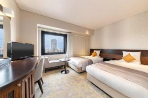 Postel nebo postele na pokoji v ubytování Art Hotel Niigata Station + 37 fotografií