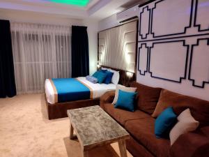 a hotel room with a couch and a bed at Ocean View Luxury Condo in Negombo