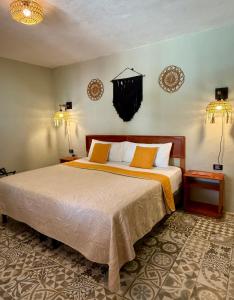 a bedroom with a large bed in a room at CASA VICTORIA in Chichén-Itzá