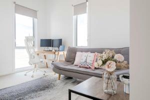a living room with a couch and a table at Torquay Beach Getaway in Torquay