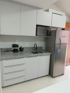Kuchyň nebo kuchyňský kout v ubytování Loft 01 dormitório