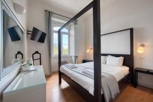 a bedroom with a large bed and a mirror at Monte da Lua in Sintra