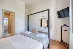 a bedroom with a bed and a tv on the wall at Monte da Lua in Sintra