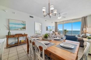 a dining room and living room with a table and chairs at Beach Club D-506 Beachfront-Tons of Amenities-3-Restaurants-Incredible Views in Gulf Shores