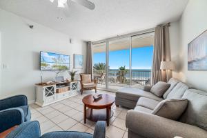 a living room with a couch and a tv at Beach Club D-506 Beachfront-Tons of Amenities-3-Restaurants-Incredible Views in Gulf Shores