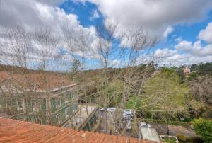 a group of cars parked in a yard with trees at Monte da Lua in Sintra