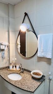 a bathroom with a sink and a mirror at Todo Azul do Mar in Taíba +36 photos
