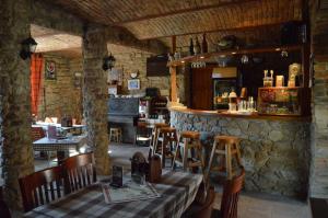 a restaurant with a table and chairs and a bar at Restaurace a penzion U Lva in Karlštejn