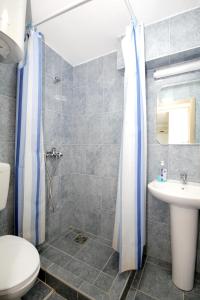 a bathroom with a shower and a toilet and a sink at Apartments Pavlovic in Petrovac na Moru +60 photos