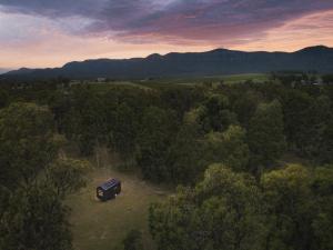 an aerial view of a truck in a field with trees at Off-Grid Cabin in the Hunter Valley - Lila in Pokolbin