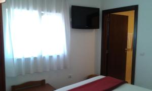 Ένα ή περισσότερα κρεβάτια σε δωμάτιο στο Hotel Tic Tac