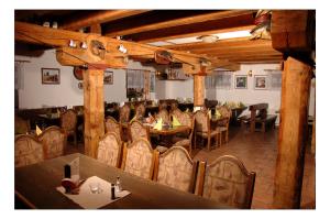 a dining room with tables and chairs in a restaurant at Penzion Daniela in Horní Planá