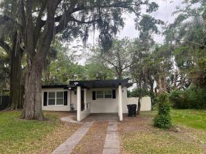 a small white house with a tree in front of it at City and Stadium Sanctuary Vibes in Orlando