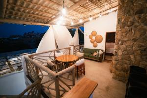 a room with a table and chairs and a bed at Saona Bangalôs Taíba in Taíba