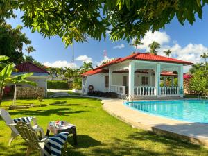 a house with a swimming pool in a yard at Mango house bliss in Las Galeras