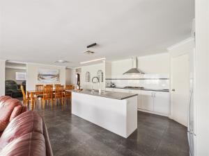 a kitchen and living room with a couch and a table at Busselton Broadwater Holiday Home in Busselton