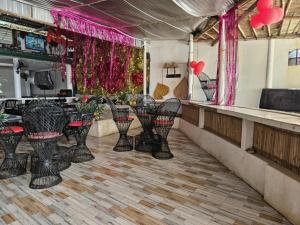 a bar with black chairs and a counter with pink decorations at wombats beach resort, bar and restaurant in Olongapo