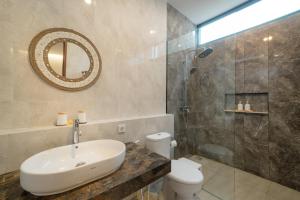 a bathroom with a sink and a toilet and a shower at Sanur Bali Villas by Premier Hospitality Asia in Sanur +18 photos
