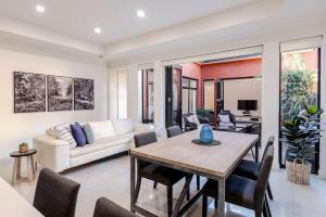 a living room with a table and a couch at The Terrace - close to Adelaide Oval Cafes CBD Shopping in North Adelaide