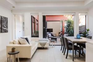 a living room with a couch and a table at The Terrace - close to Adelaide Oval Cafes CBD Shopping in North Adelaide