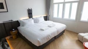 Postel nebo postele na pokoji v ubytování Santisookmidtown Pattani