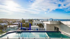 a swimming pool on the roof of a building at Elysee Beachside Apartments Alexandra Headland in Alexandra Headland