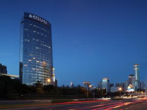 un edificio alto con un cartel en él por la noche en 深圳花园格兰云天大酒店-免费迷你吧&延迟14点离店 en Shenzhen