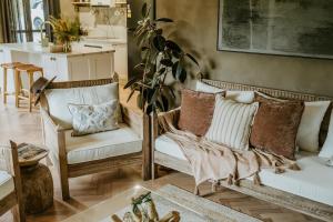 a living room with two chairs and a table at The Temple - Country Farm Retreat in Launching Place