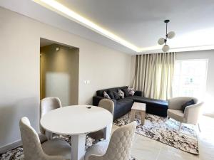 a living room with a couch and a table and chairs at Golden House Madinty in Madinaty