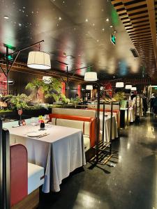 a dining room with tables and chairs and lights at The North Garden Hotel Beijing Wangfujing in Beijing