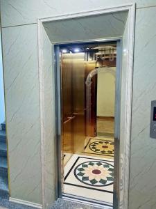 a glass door leading into a hallway with a rug at thieuki 1 in Hà Tĩnh