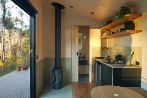 a kitchen with a stove in the middle of a room at Ribbon Gum Retreat in Reidsdale