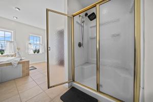 a bathroom with a shower with a glass door at Spacious 6 BR Villa - Serene Scenic Mountain Escape in Bloomingburg +42 photos