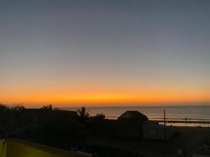 a sunset on the beach with the ocean in the background at Casa Española del Mar in Cartagena de Indias +3 photos