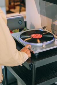 a person is putting a record in an oven at Pause Apartment in Da Lat