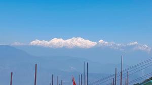 a view of a snow covered mountain in the distance at The Mountain Range Homestay in Darjeeling
