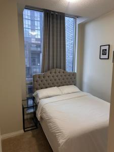 a bed in a room with a large window at Private and Comfort Room in Mississauga
