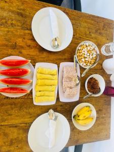 a table with plates and bowls of food on it at Villa kandupamula in Mirissa +34 photos
