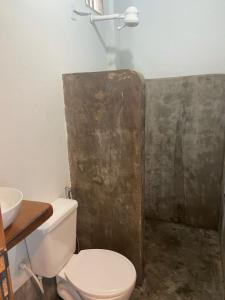 a bathroom with a toilet and a sink at Sol Suítes Caraíva in Porto Seguro