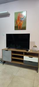 a entertainment center with a flat screen tv on top at La casa de Bába in San Salvador