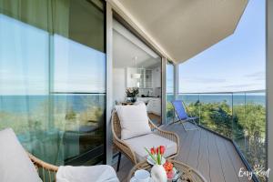 a balcony with a view of the ocean at Prestige 613 - tuż przy plaży - basen, sauna, jacuzzi w cenie pobytu - Easy - Rent Apartments in Pobierowo