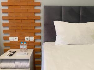 ein Schlafzimmer mit einem Bett und einer Ziegelwand in der Unterkunft Swiss-Belexpress Rest Area KM 166 Cipali 