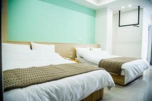 Postel nebo postele na pokoji v ubytování 嘉義旅人 Chiayi Traveler