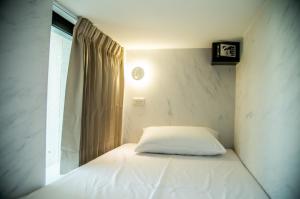 Postel nebo postele na pokoji v ubytování 嘉義旅人 Chiayi Traveler