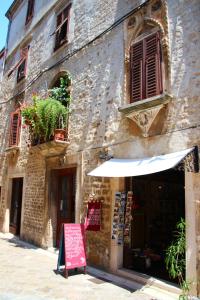 an old building with a sign in front of it at Petrizio Palace in Zadar