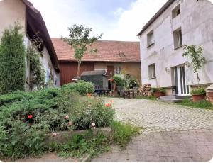 a garden in front of a building at Farm Privatzimmer Gina Free WiFi in Hausbreitenbach