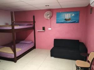 a room with two bunk beds and a couch at Ayah Perhentian in Perhentian Island +10 photos